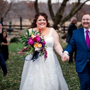 Bride with Jewel Tone Bouquet and Groom with Fuschia Tie at Wisconsin Barn Wedding Ceremony